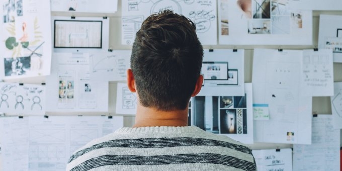 Designer looking at a wall of product development ideas.